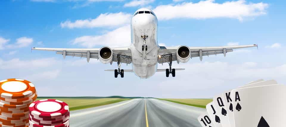 An airplane taking off, with casino chips and cards below.