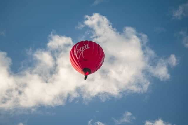 A red Virgin hot air balloon in the sky.