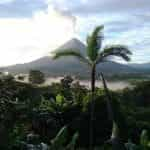 A volcano erupts over the jungle in Costa Rica.