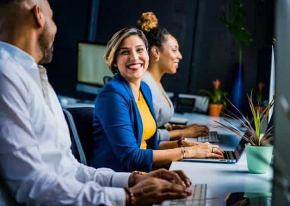 Men and women working in an office.