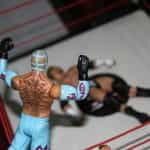 Figurines of two WWE fighters face off in the ring.