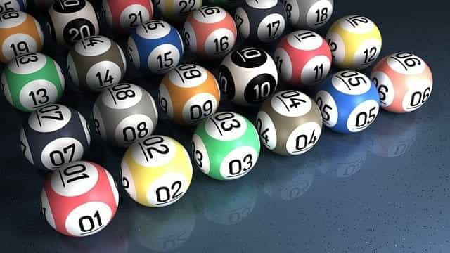 Multicolored bingo balls with numbers on.