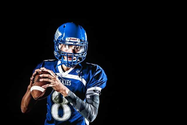 A male American football player in a blue outfit.