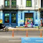 A motorbike delivery person rides past a graffiti-covered wall in Concepcion, Chile.