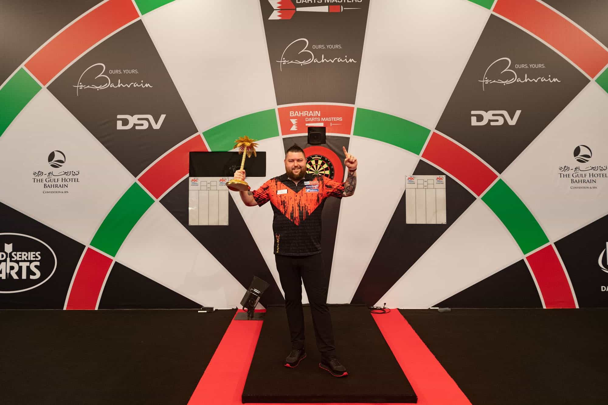 Winner Michael Smith poses with his Bahrain Darts Masters trophy.