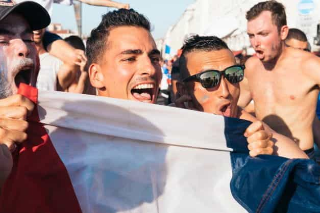 French sports supporters posing with a flag.