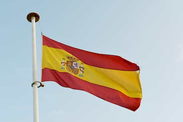 The Spanish flag waves in a flagpole.