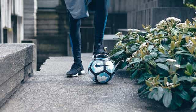 A footballer with a ball.