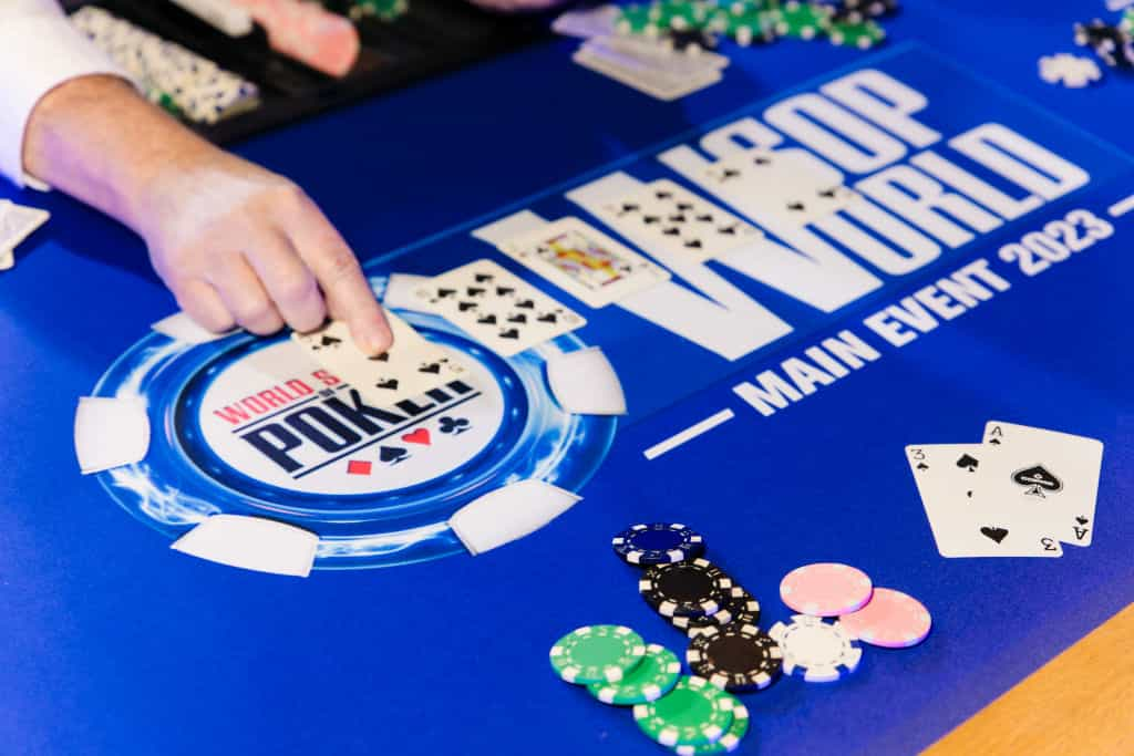 Players sit around a World Series of Poker branded table.