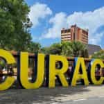 A large yellow sign spells out the name Cura?ao in the city of Willemstad, Cura?ao.