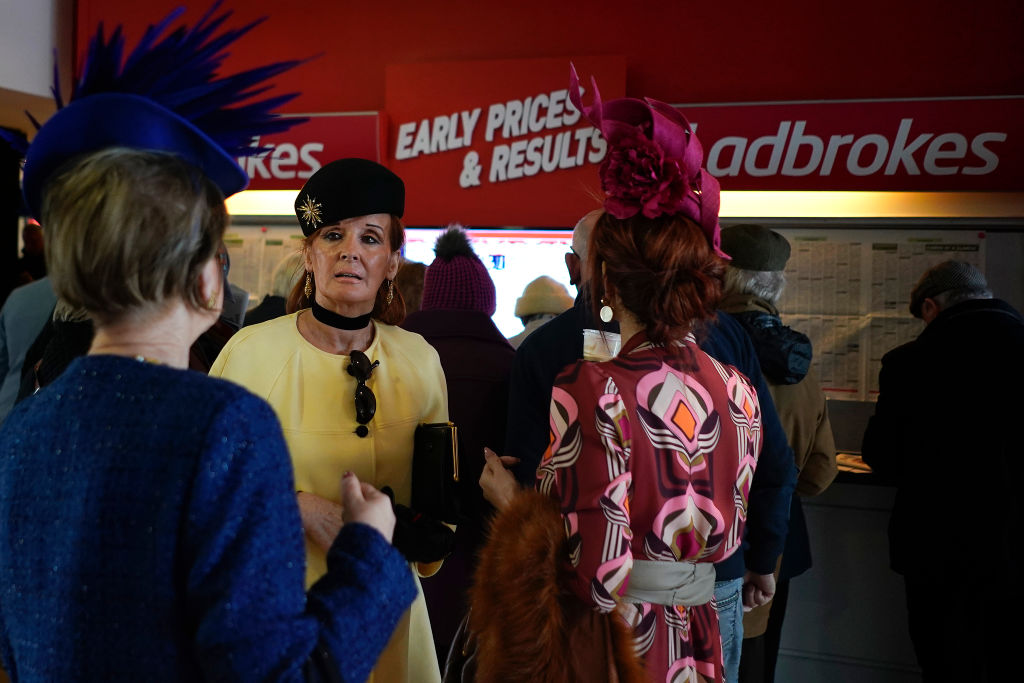 Smartly dressed women outside Ladbrokes betting shop in Punchestown Racecourse.